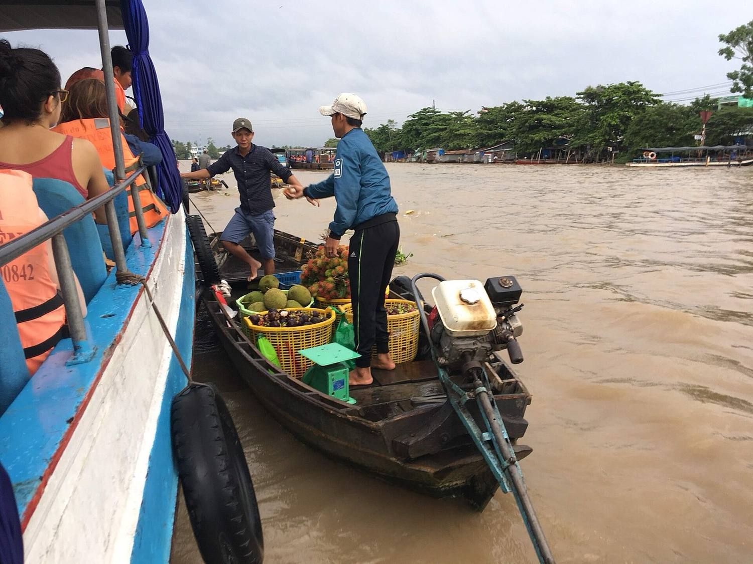 Wooden boats loaded with fruit trading at Cai Rang floating market at dawn