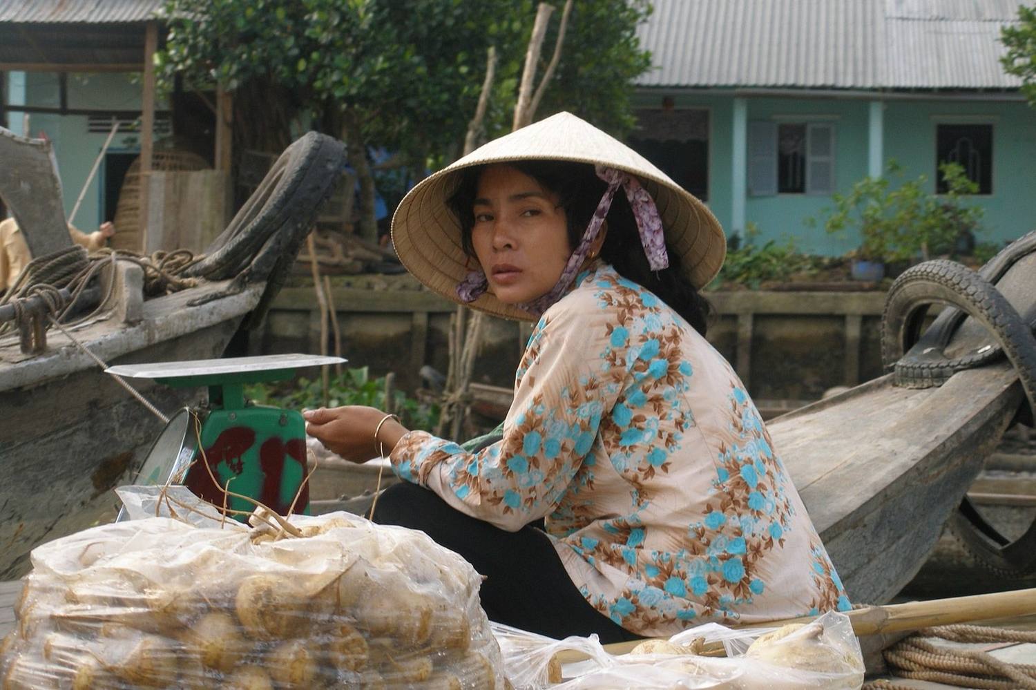 A woman selling produce from her boat at a Mekong Delta floating market