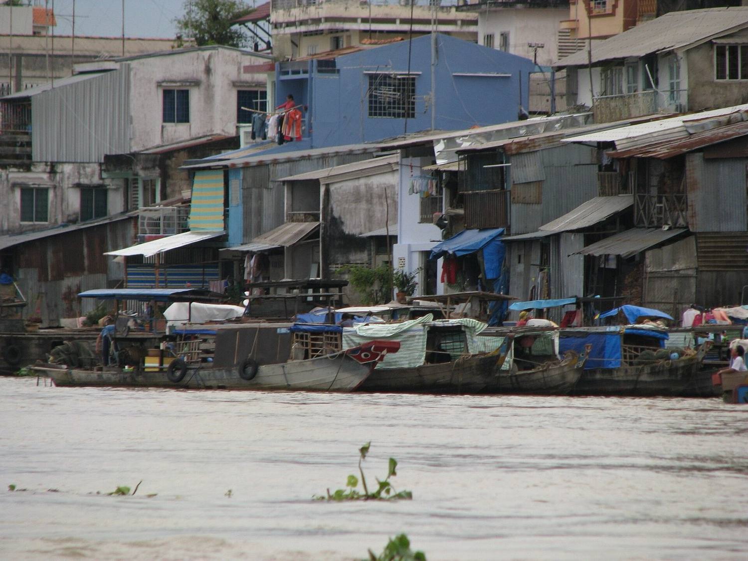 Riverside houses and boats on a Mekong Delta waterway